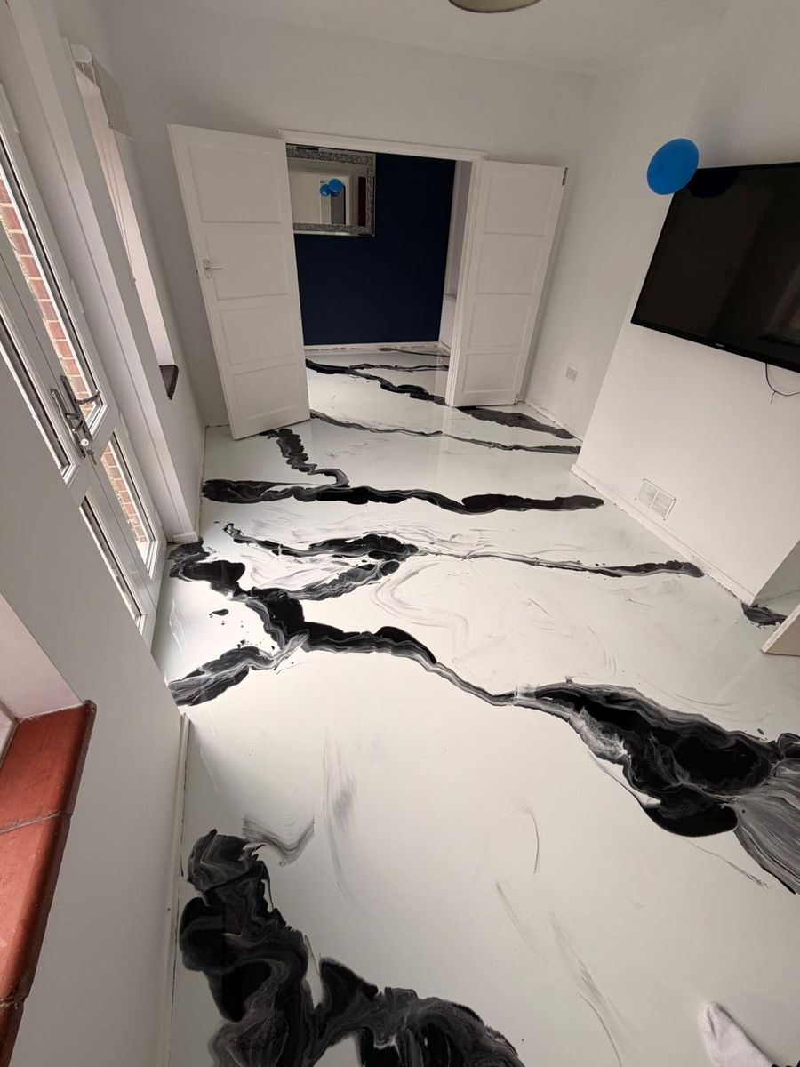 Black and white marble-effect poured resin floor in a living room